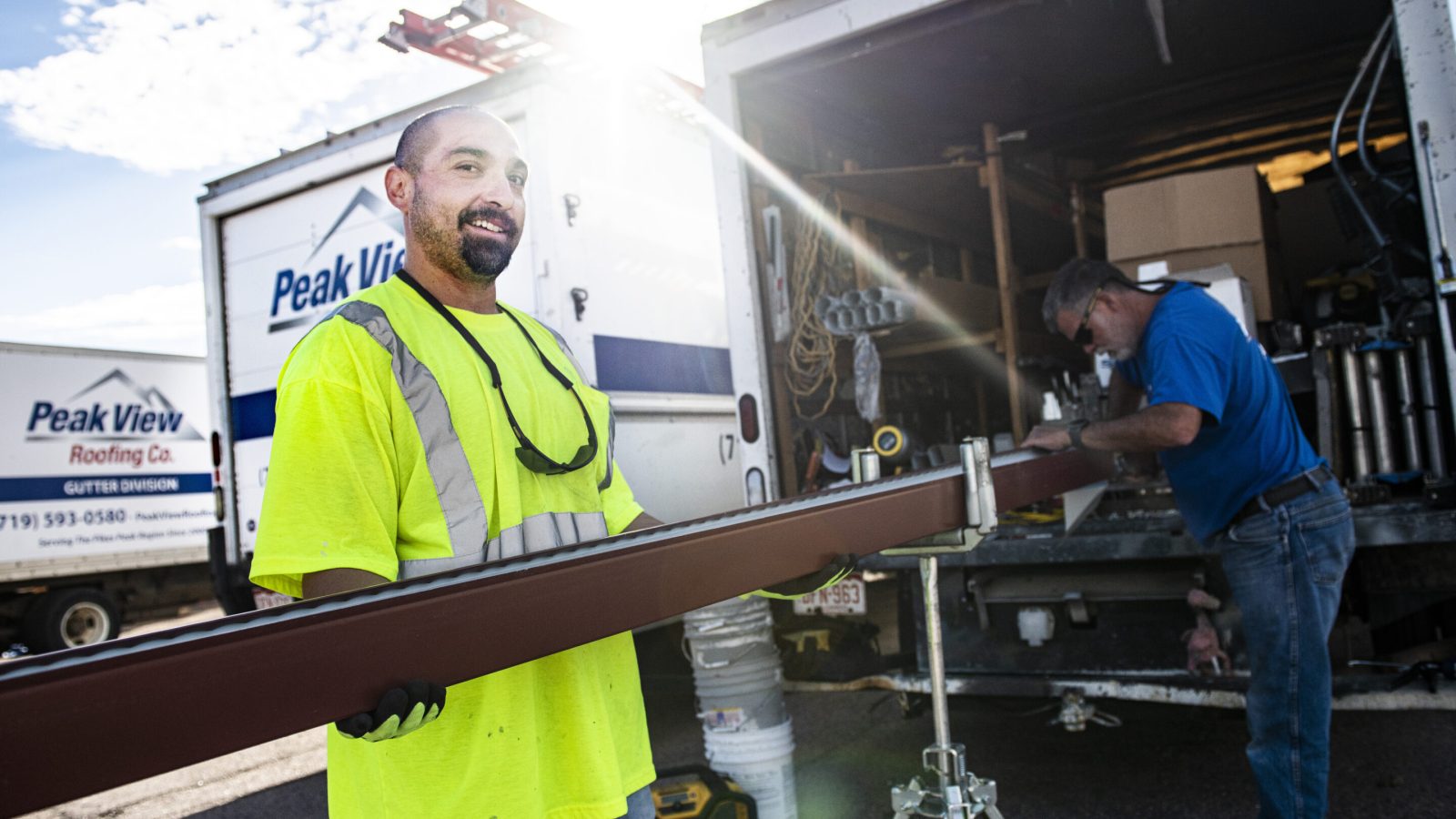 Two men working on gutters